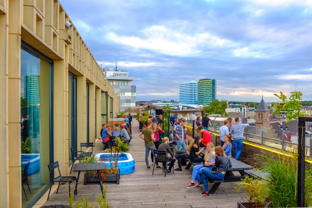 people sitting on chairs near building during daytime