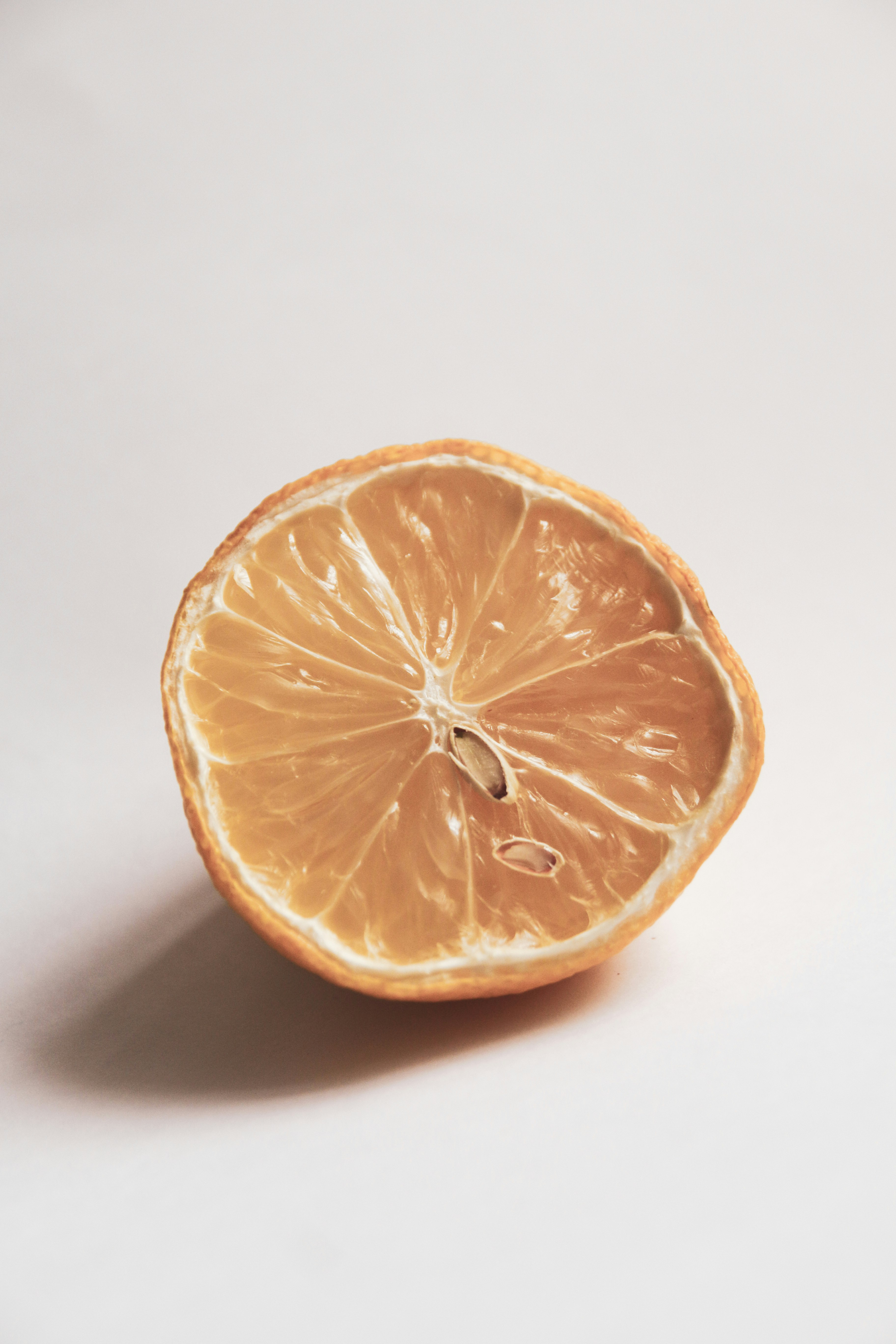 sliced orange fruit on white surface