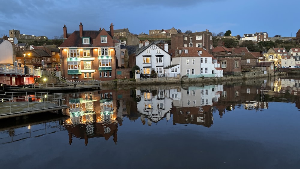 brown and white concrete buildings beside body of water during daytime