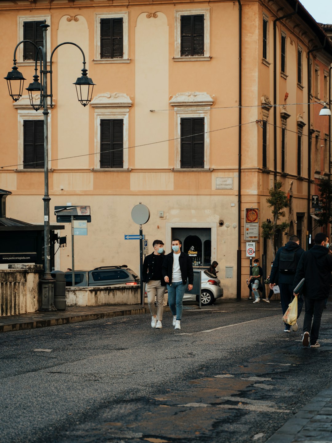 people walking on sidewalk near building during daytime