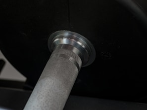 Close-up of a weightlifting barbell loaded with weights.