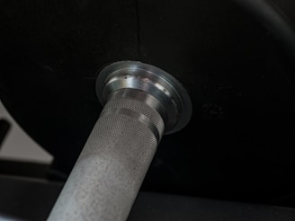 Close-up of a weightlifting barbell loaded with weights.