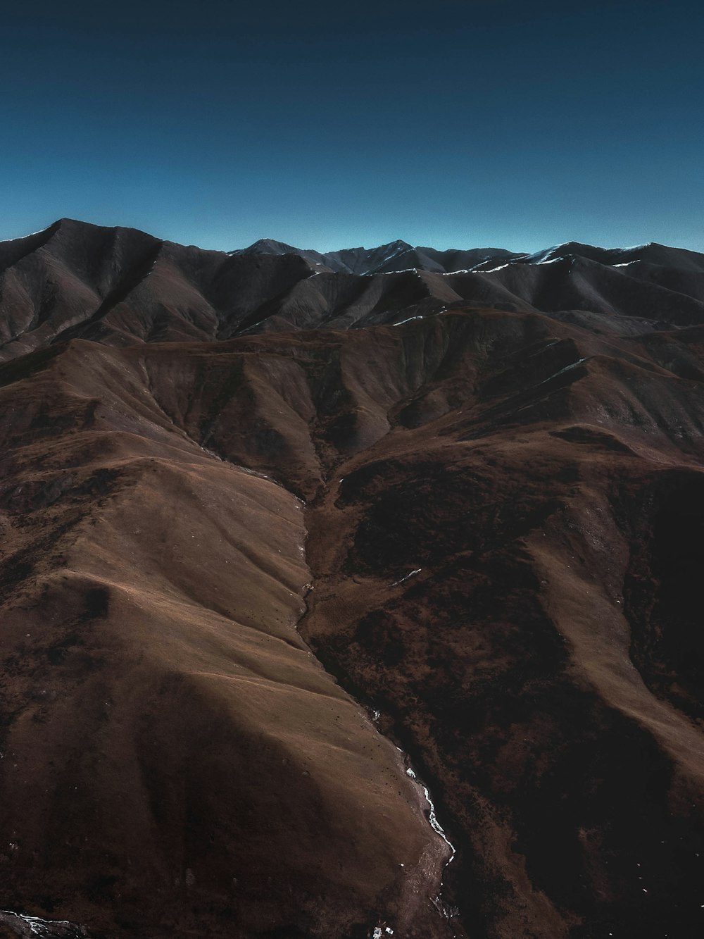 brown rocky mountain under blue sky during daytime