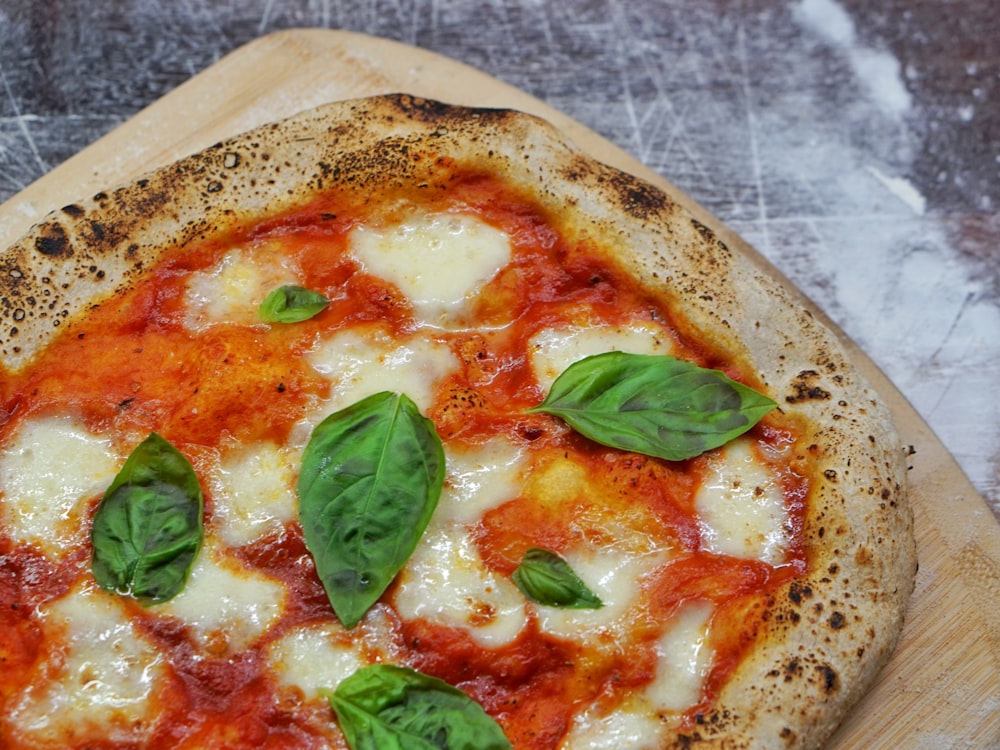 pizza with basil leaves on top