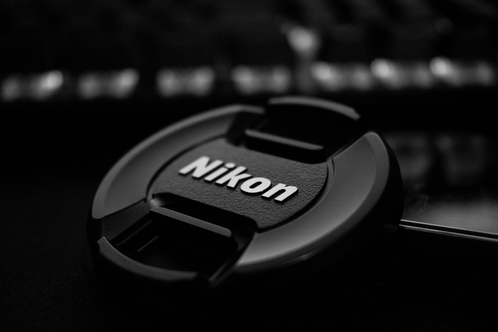 black nikon camera lens cover