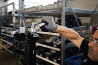 person holding black and silver steel tool