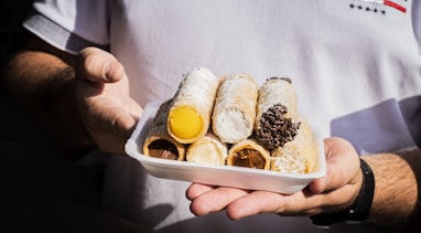 person holding white plastic container with bread