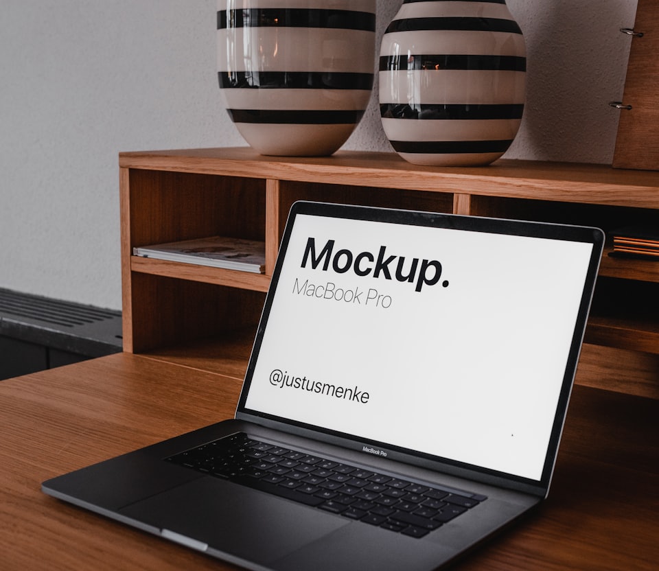 black and silver laptop computer on brown wooden table