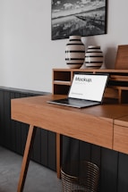 black laptop computer on brown wooden desk