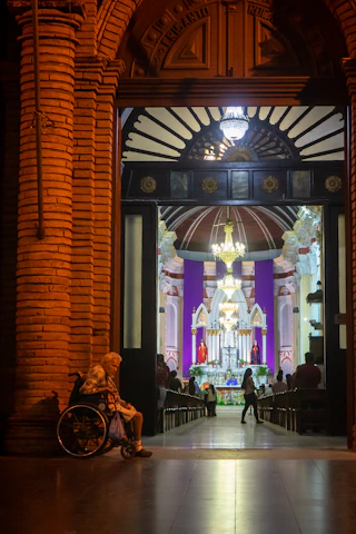Pastor warmly greeting church members in a bright, contemporary setting.