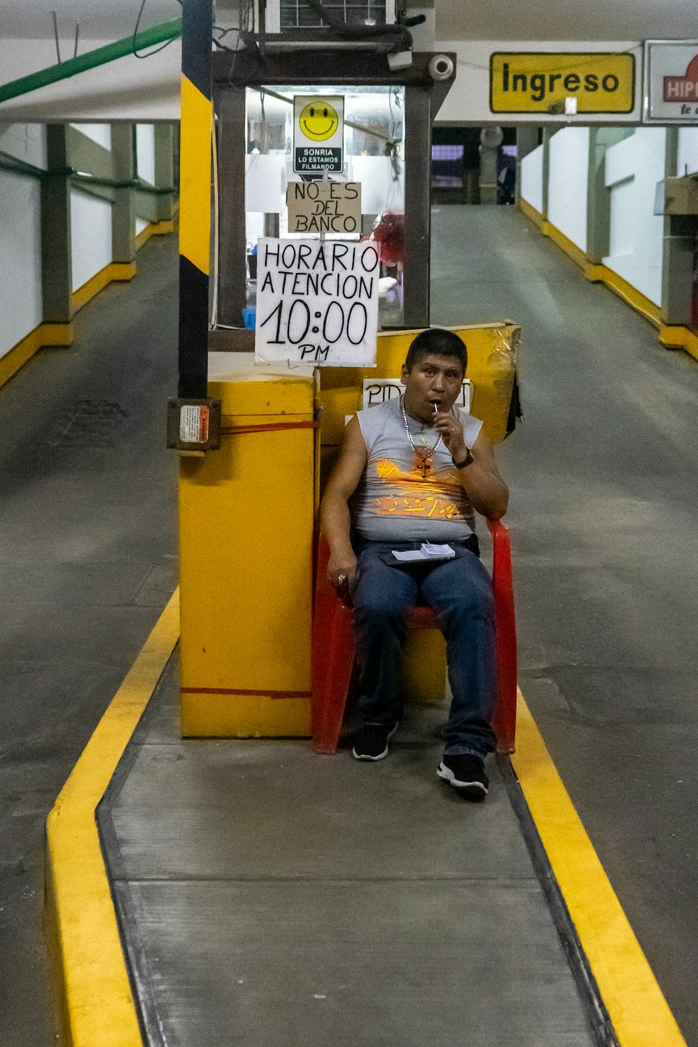 woman in white shirt sitting on yellow and red metal bench