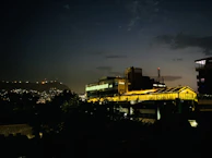 Evening exterior of the mich industrial building glowing warmly under soft lights.