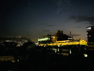 Evening exterior of the mich industrial building glowing warmly under soft lights.