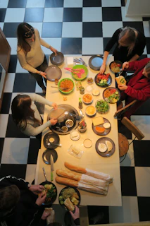 Students gathered around a kitchen island, tasting and sharing their speedy homemade dishes with smiles