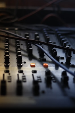 Close-up of a music production setup with mixing console and headphones.