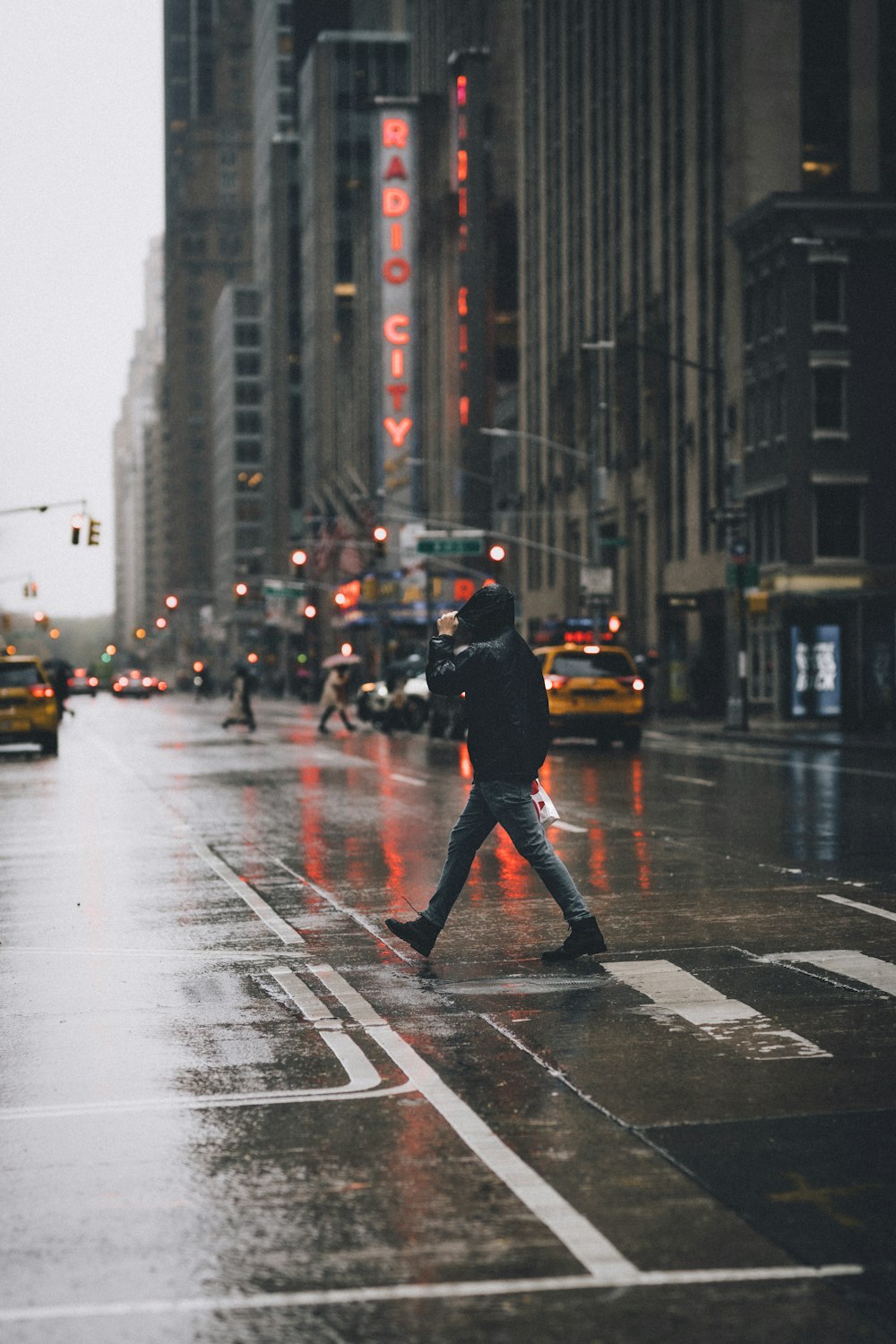 man in black jacket and pants standing on road during daytime