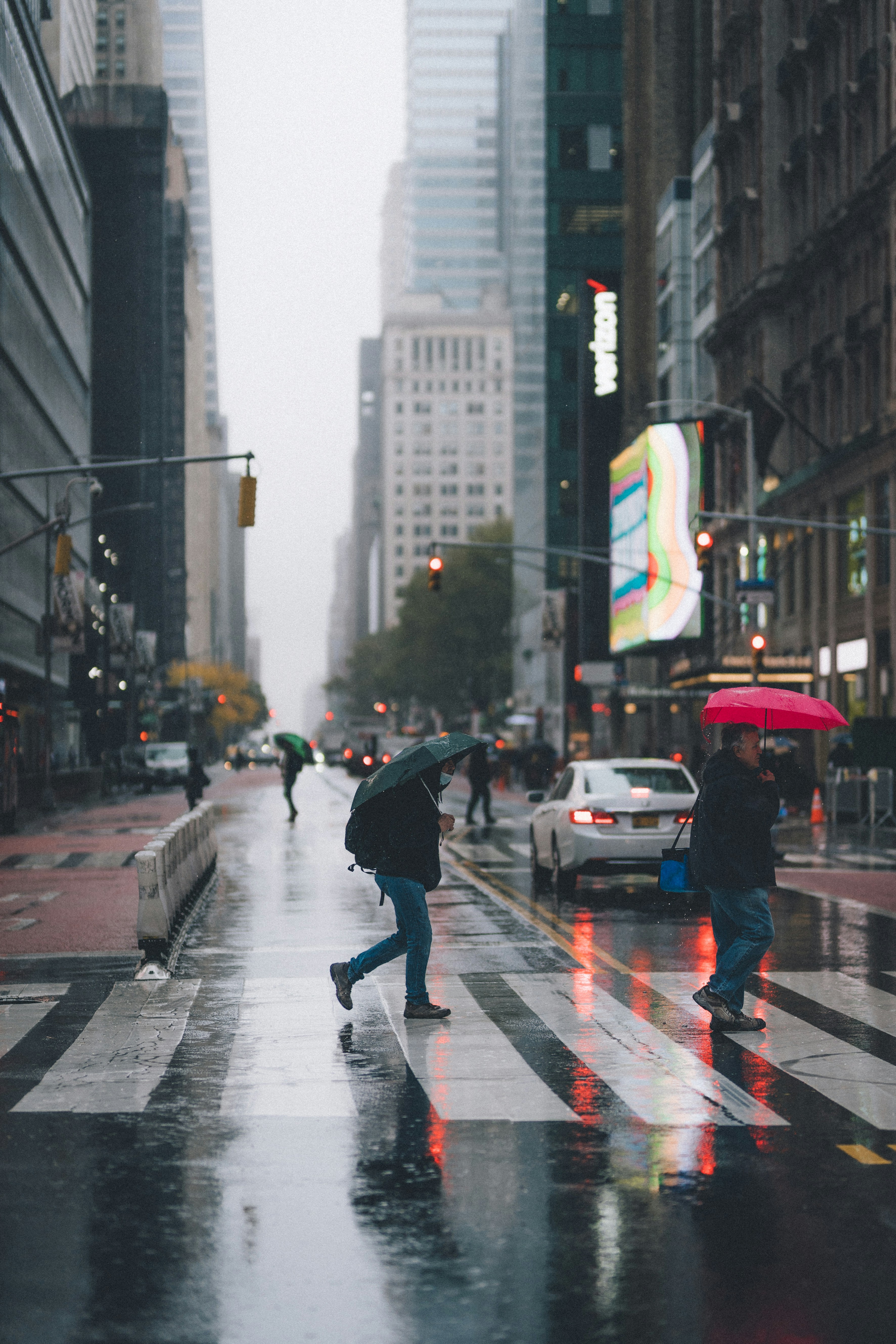 man-in-black-jacket-and-pants-walking-on-pedestrian-lane-during-daytime