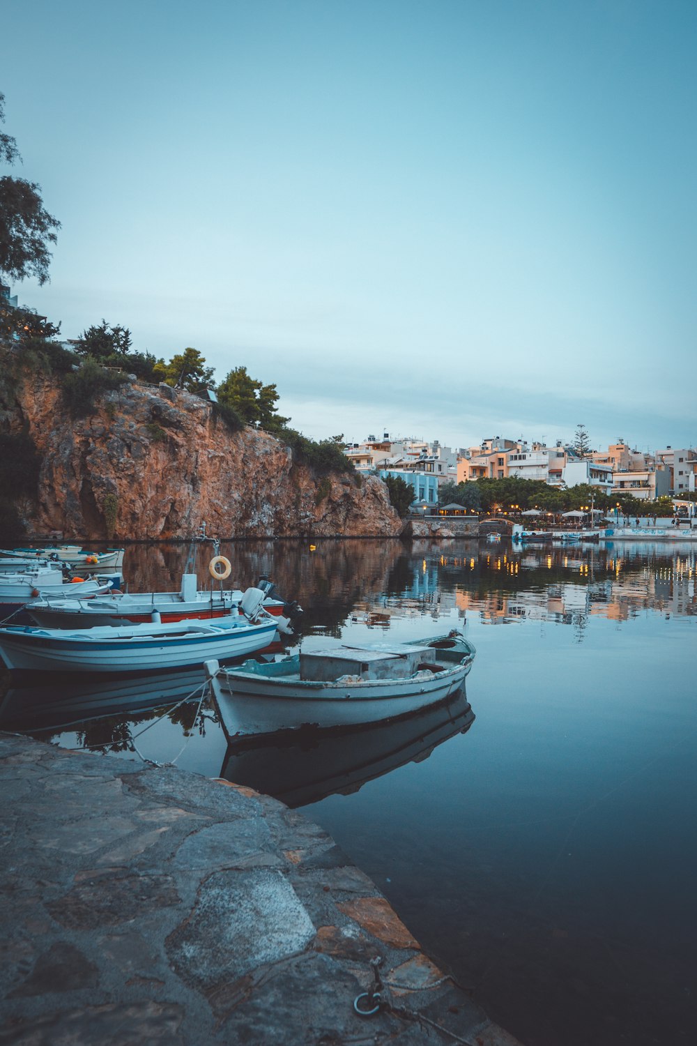 white and blue boat on body of water during daytime