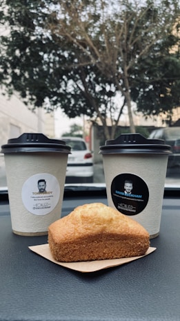Close-up of a truck's dashboard with insurance documents and a coffee cup resting nearby.