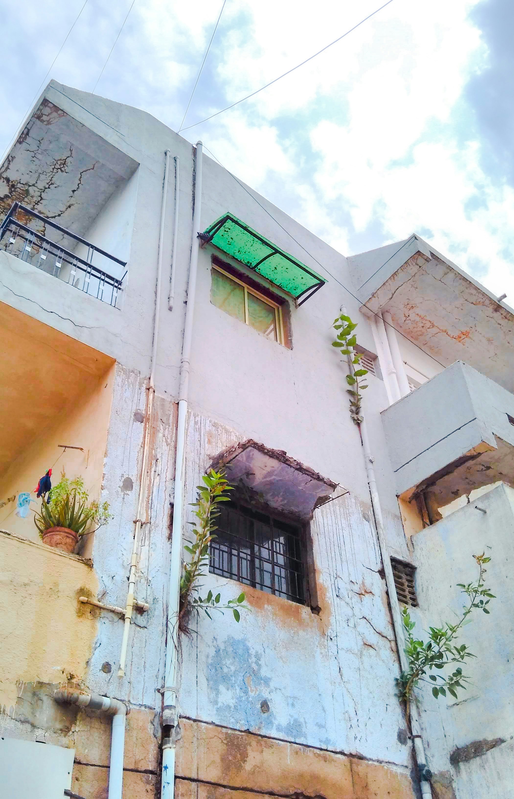 beige concrete building with green window