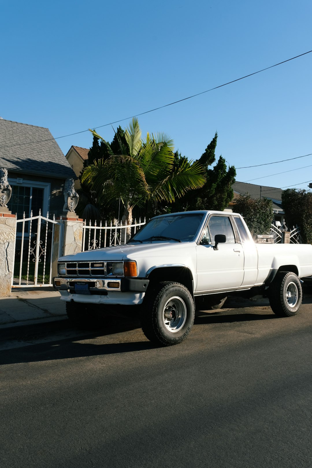 white chevrolet single cab pickup truck on road during daytime