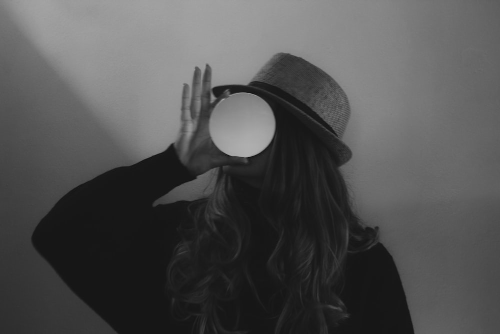 woman in black long sleeve shirt wearing brown hat