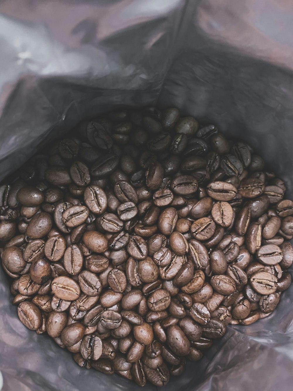 brown coffee beans in plastic bag