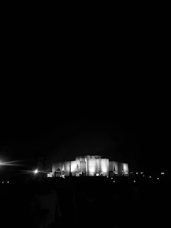 A night shot of a government building project illuminated, highlighting precision and scale.