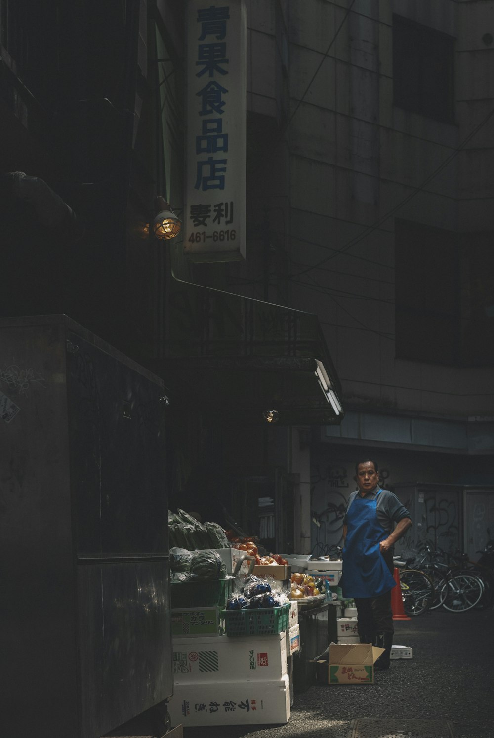 Mann in rotem T-Shirt und blauer Jeans in der Nähe eines Imbissstandes in der Nacht