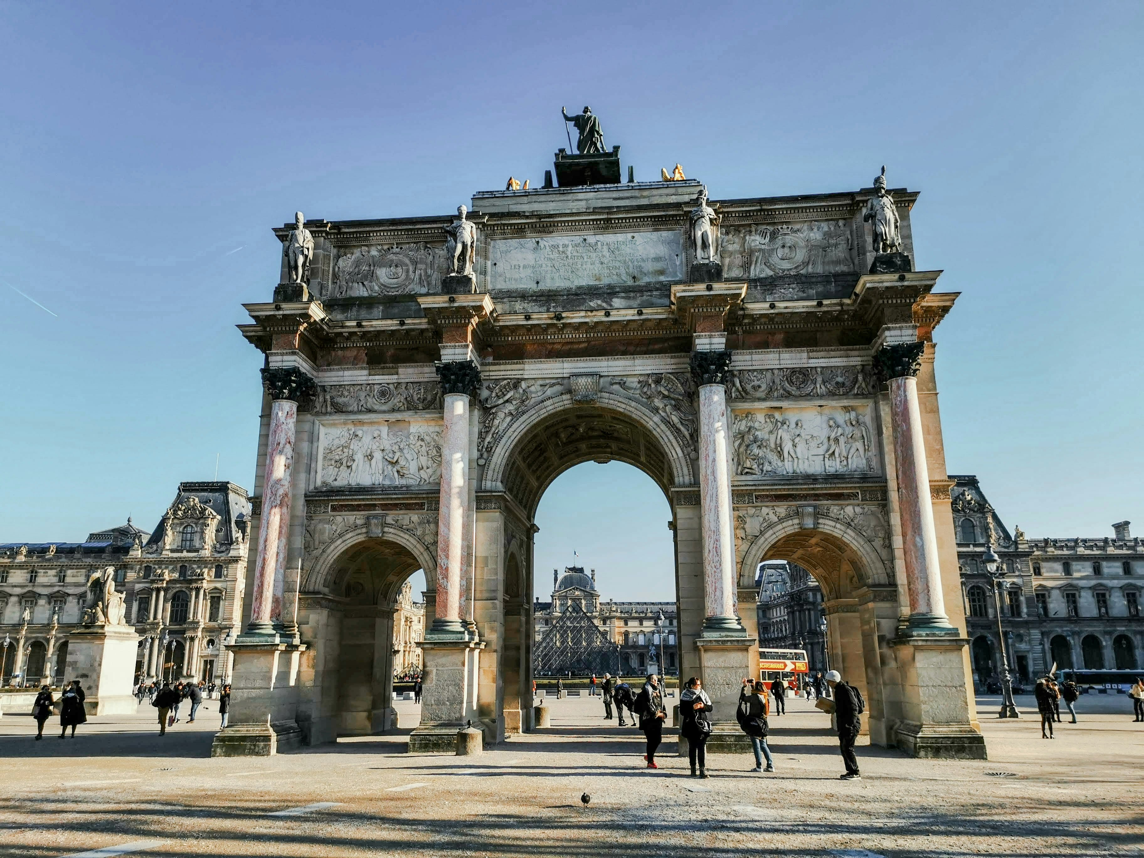 people walking on gray concrete arch during daytime