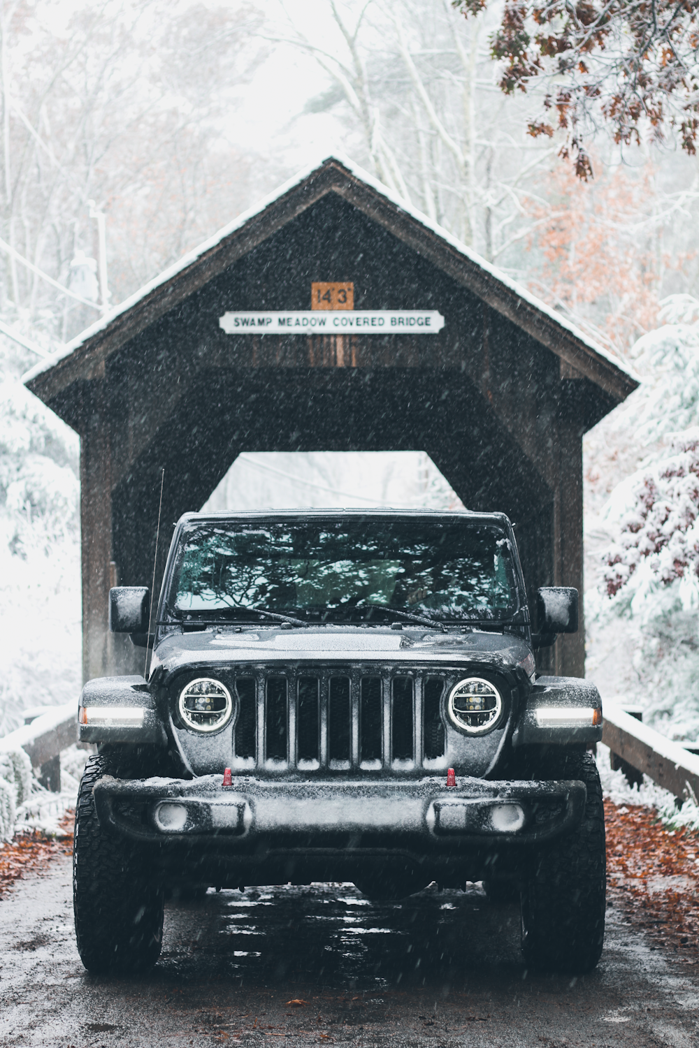 black jeep wrangler in front of gray concrete wall