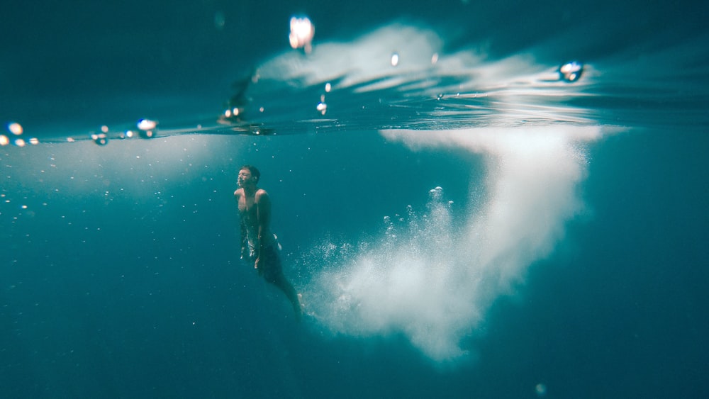 2 men in water with white clouds