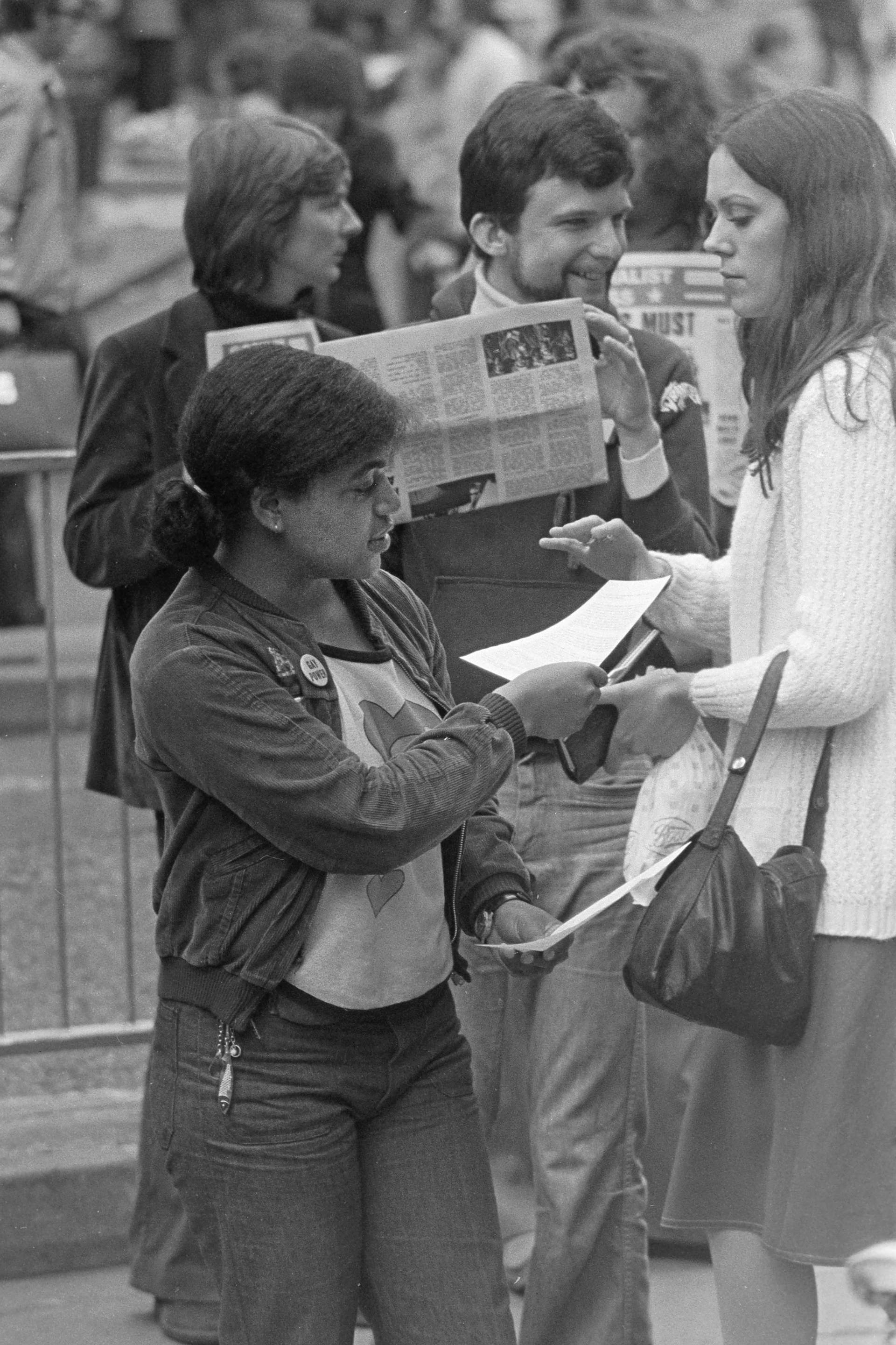 man in gray jacket holding paper