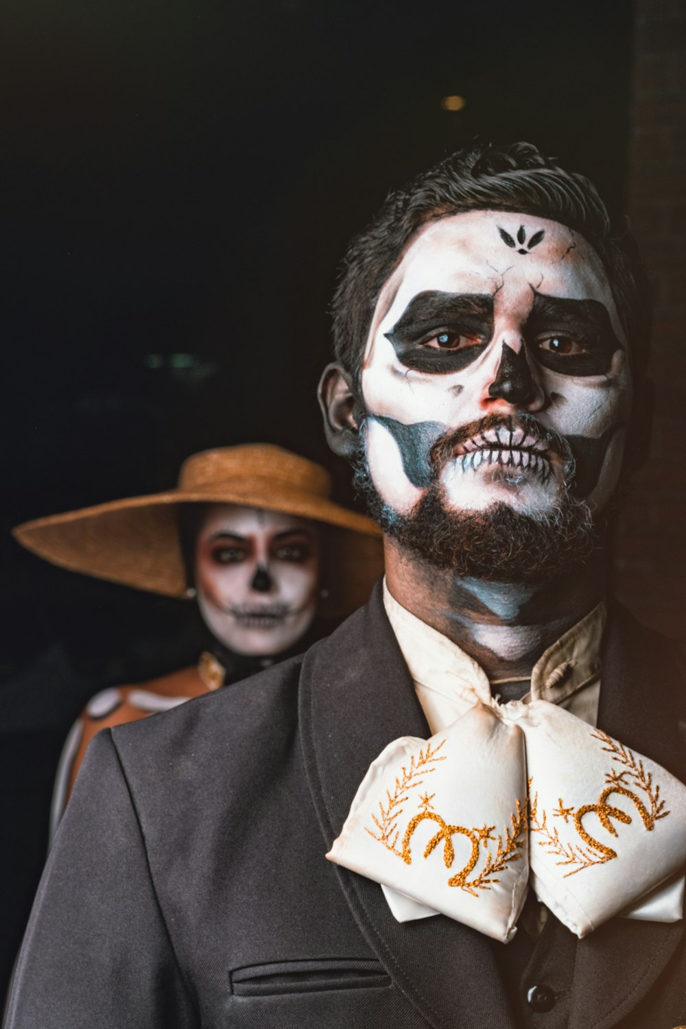 man in black suit with white and black face paint