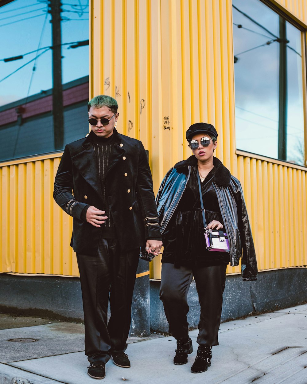 man in black coat standing beside man in black leather jacket