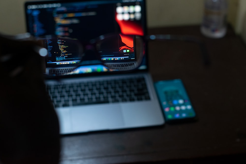 macbook pro beside black remote control