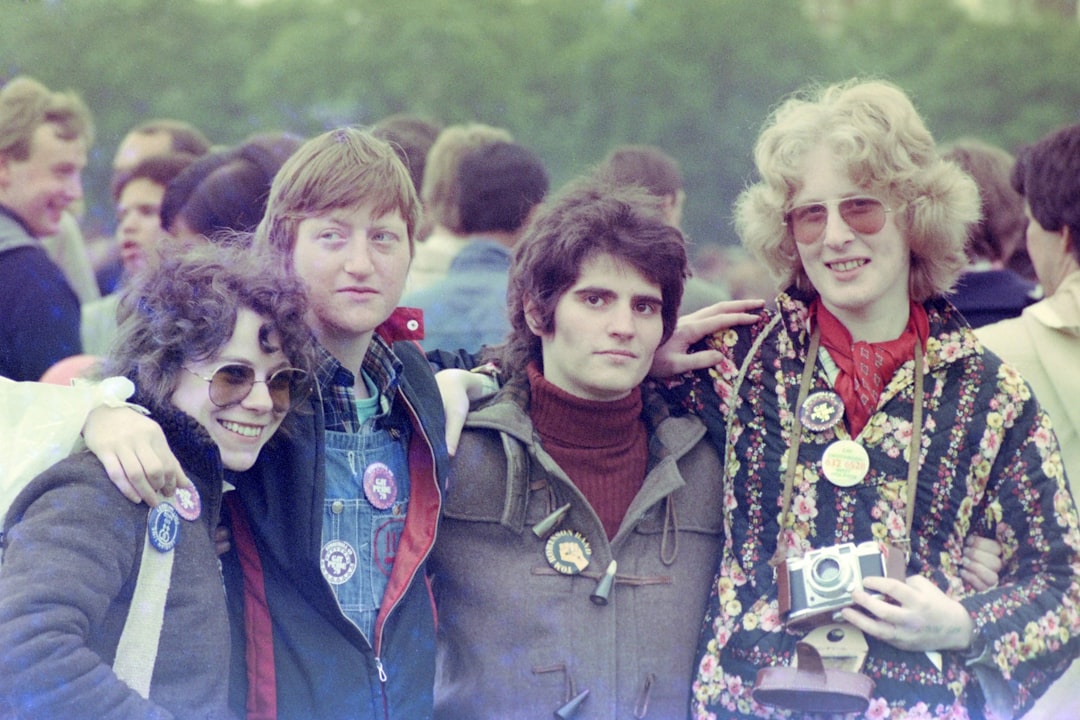 woman in blue denim jacket standing beside girl in red jacket, Gay Pride 1979
