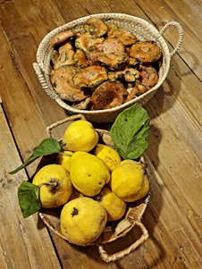 A vibrant harvest basket filled with fresh huitlacoche, mushrooms, and Brussels sprouts on a rustic wooden table.
