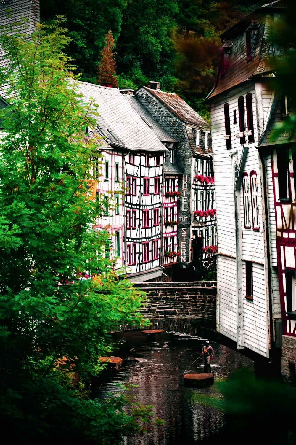 white and red wooden houses near green trees during daytime