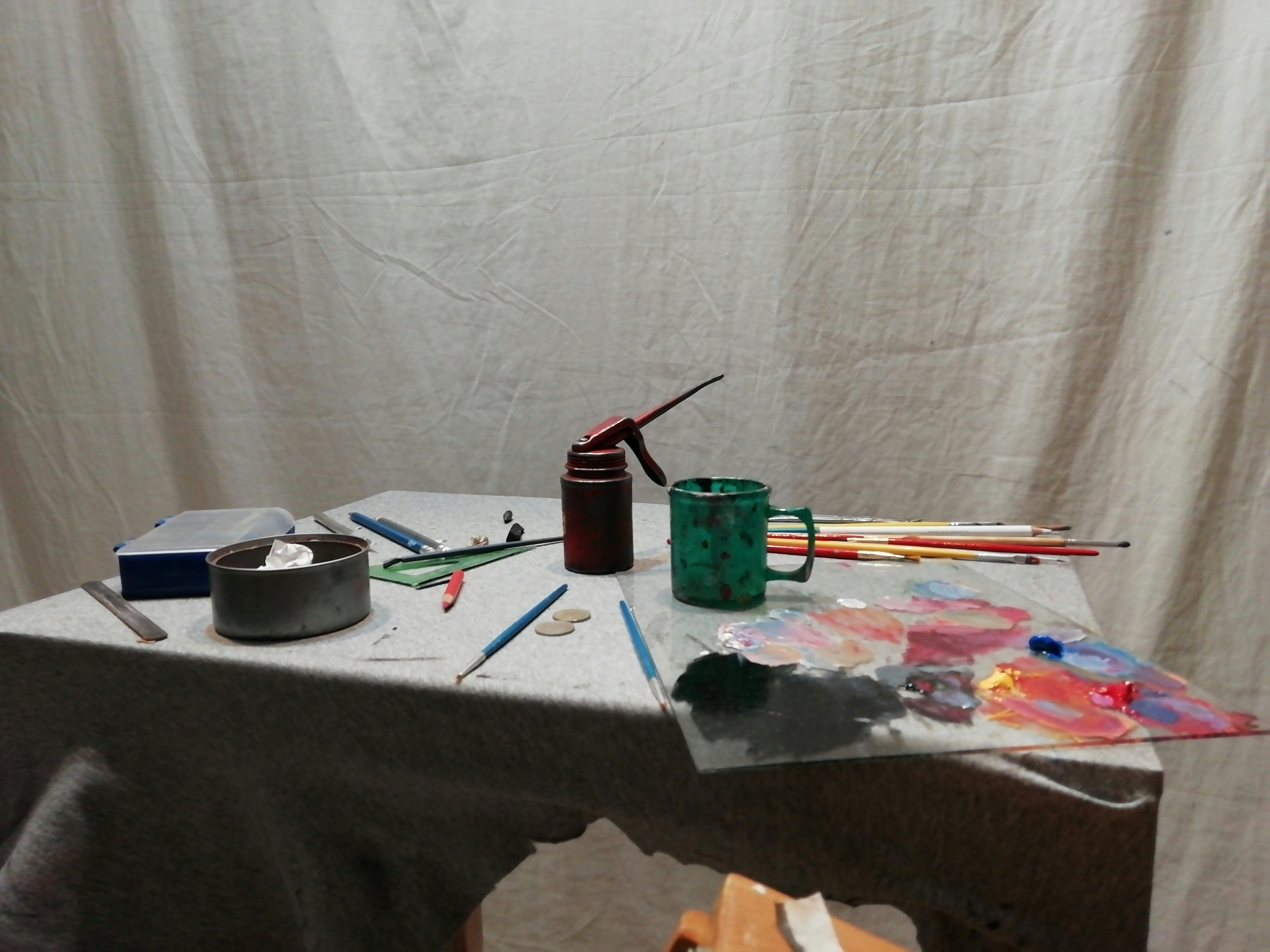 Green and black bottle on white table