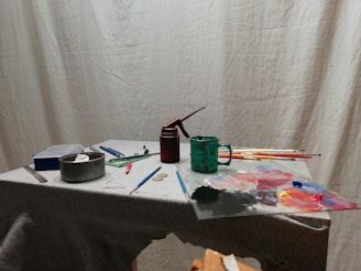 green and black bottle on white table