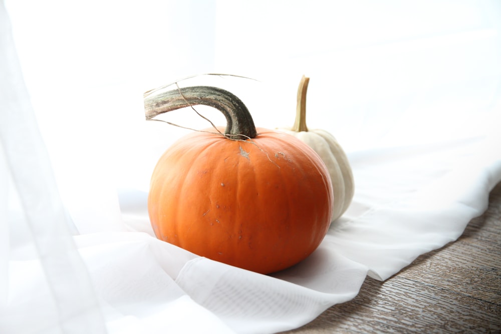 orange pumpkin on white textile