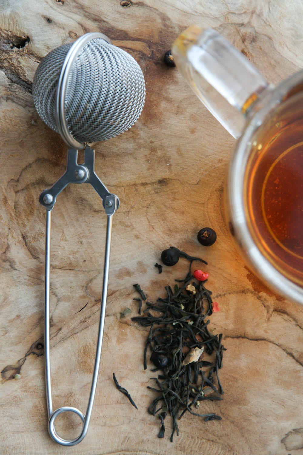 stainless steel strainer on brown wooden table