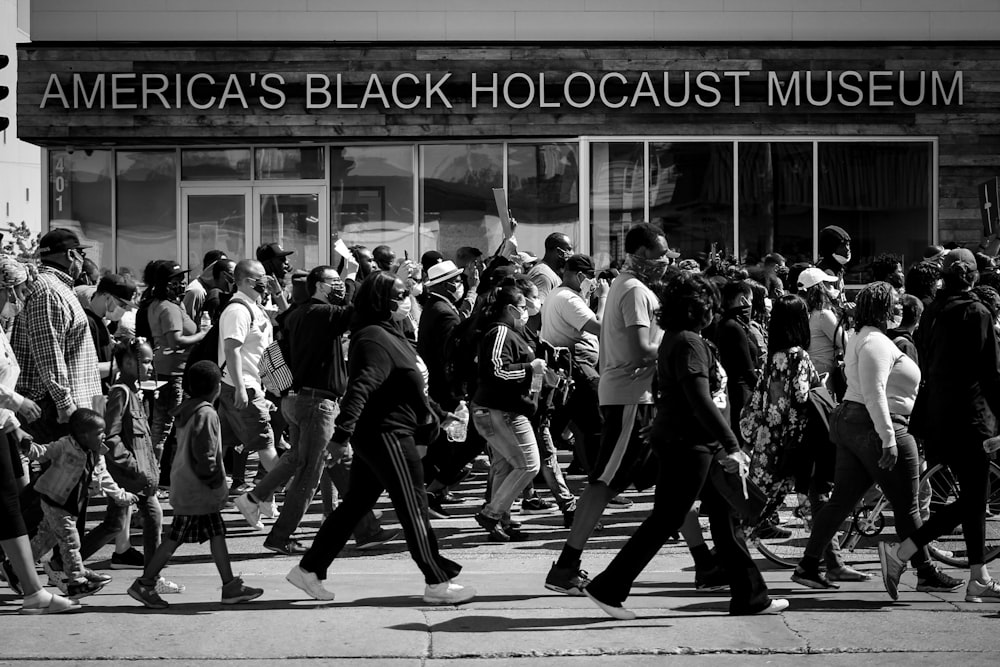 grayscale photo of people walking on street