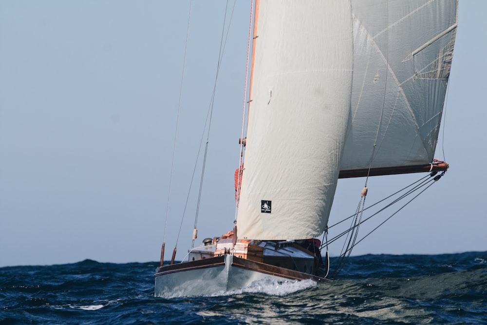 white and brown sailboat on sea during daytime