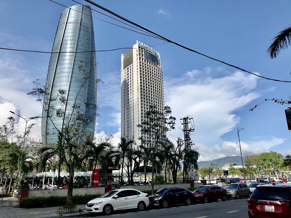 cars parked on parking lot near high rise building during daytime