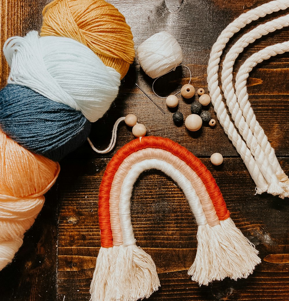 blue and orange yarn on brown wooden table