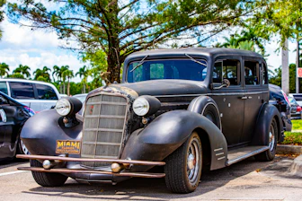 A damaged car being loaded onto a tow truck in Miami Beach