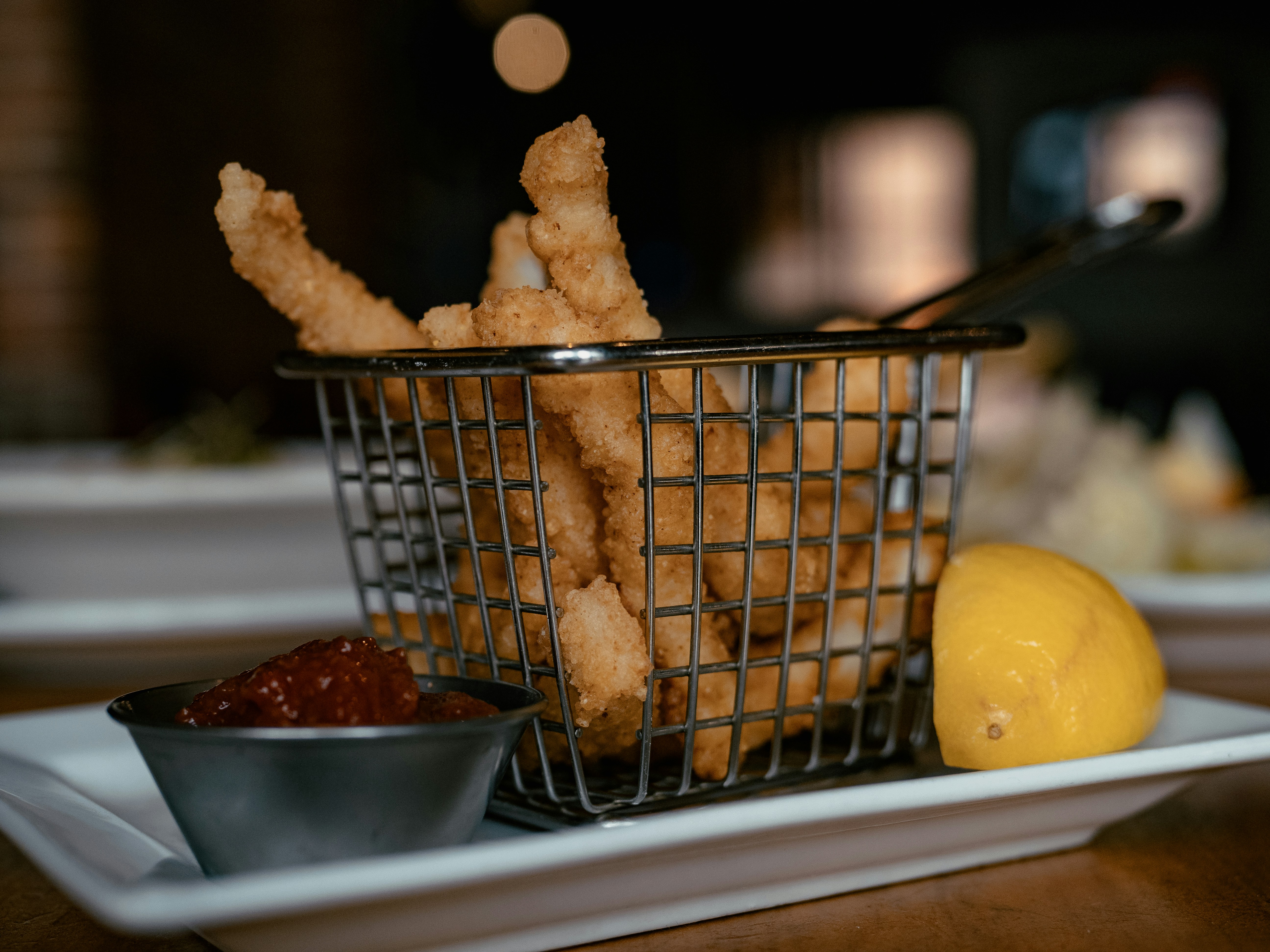 A plate of appetizers including wings and nachos