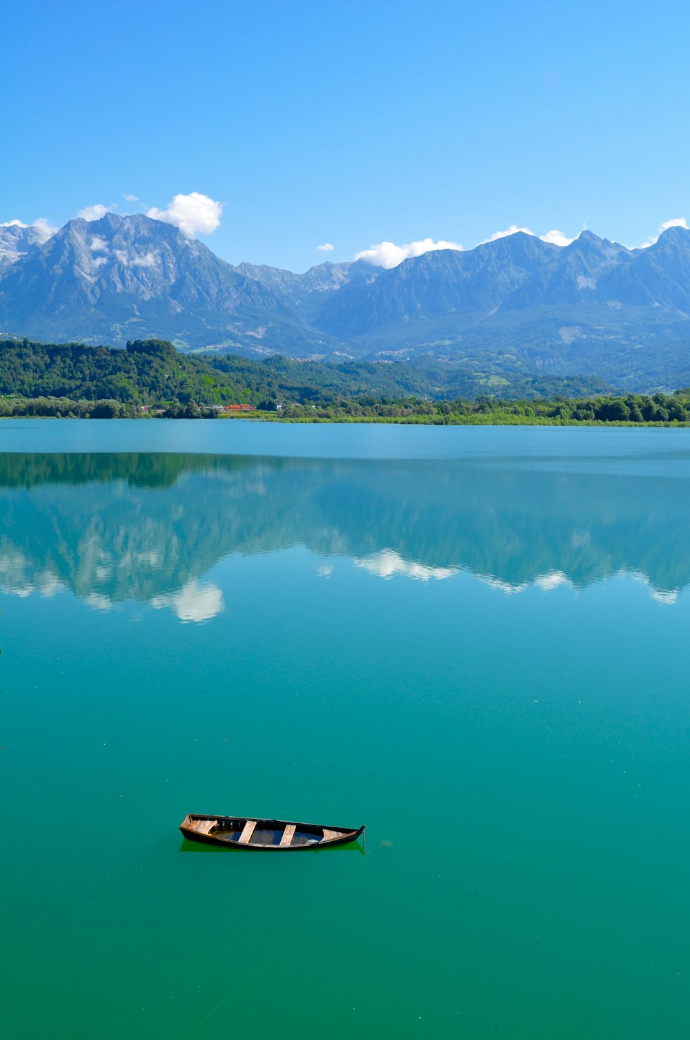 brown wooden boat on lake during daytime